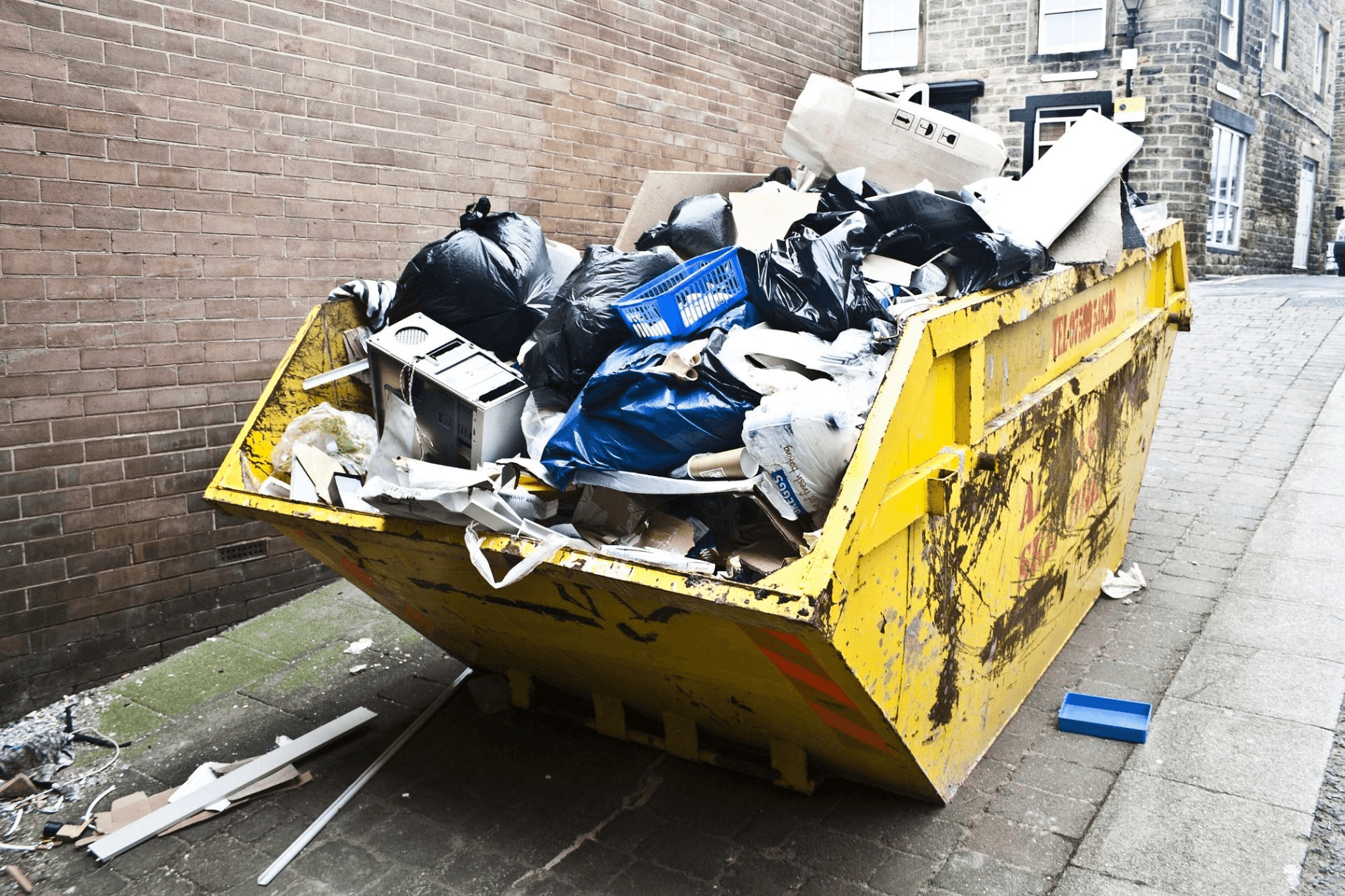 Yellow skip bin properly placed on street for waste collection