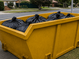 Cropped close-up of a skip bin with no road context